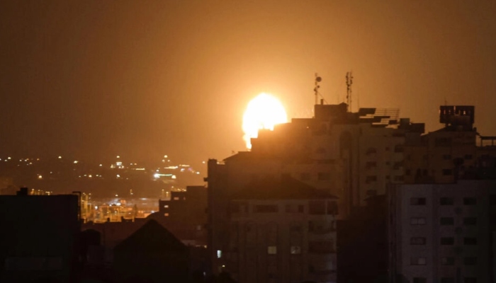 Flames and smoke arise above a building after Israeli airstrikes in Gaza, July 2023 – AFP/Files