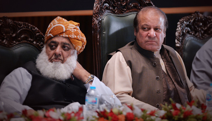 JUI-F Molana Fazl-ur-Rehman (left) with PML-N supremo Nawaz Sharif during a seminar in Islamabad on April 17, 2018. — AFP