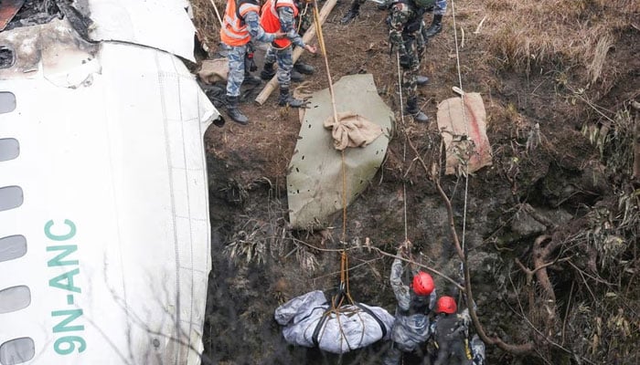 A rescue team recovers the body of a victim from the site of the plane crash of a Yeti Airlines operated aircraft, in Pokhara, Nepal January 16, 2023. Reuters