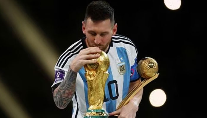 Soccer Football - FIFA World Cup Qatar 2022 - Final - Argentina v France - Lusail Stadium, Lusail, Qatar - December 18, 2022, Argentinas Lionel Messi kisses the World Cup trophy after receiving the Golden Ball award as he celebrates after winning the World Cup. —REUTERS