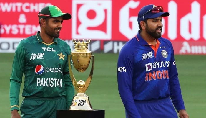 Pakistan and Indian skippers Babar Azam and Rohit Sharma pose with the Asia Cup trophy. — AFP