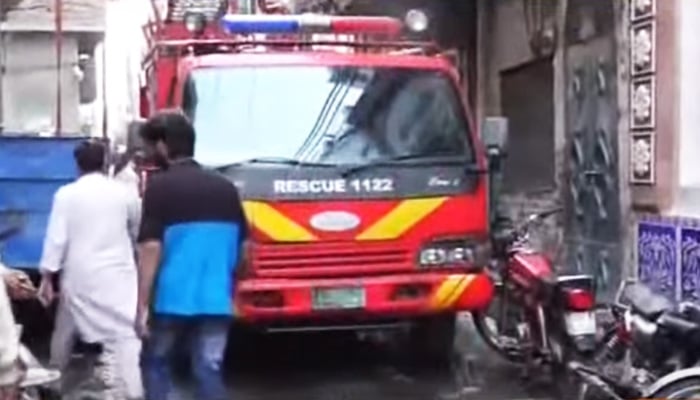 A Rescue 1122 vehicle stands outside the affected building amid cooling process in this screengrab. — YouTube/Geo News