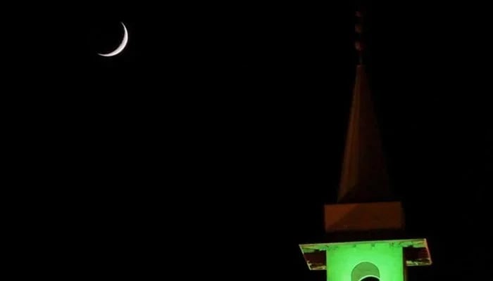 A crecent is seen on the dark sky in the background of a minaret in this undated image. — Reuters/File