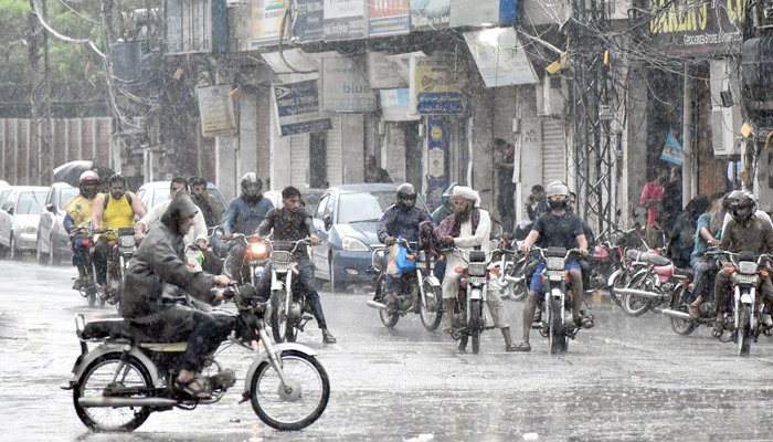 Motorists are on their way during rain fall as the continuous rain from two days make the weather pleasant, in Islamabad on July 6, 2023. — Online