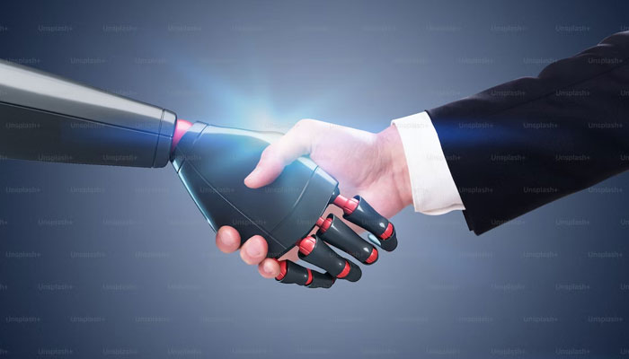 This representational picture shows a man shaking hands with a robot. — Unsplash/File