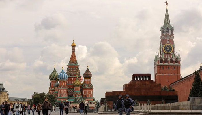 People walk across Red Square near St. Basils Cathedral and the Kremlins Spasskaya Tower in central Moscow, Russia. — Reuters/File