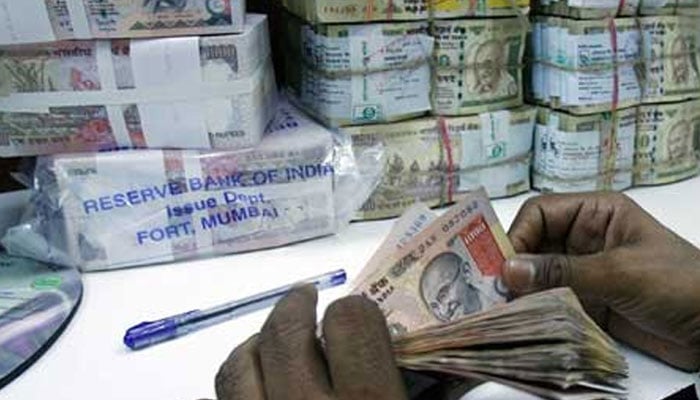 In this undated photo, a man is counting Indian currency notes. — AFP/File