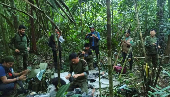 Colombian soldiers treat the four Indigenous children who were found alive on June 9, 2023 after spending more than a month lost in the Colombian Amazon jungle following the crash of a small plane. Colombian govt handout