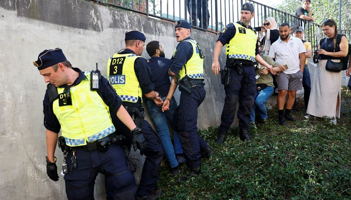Police officers intervene after peoples reaction as demonstrators burn the Holy Quran (not pictured) outside Stockholms central mosque in Stockholm, Sweden June 28, 2023. — Reuters