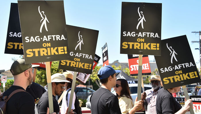 Members of the Writers Guild of America and Screen Actors Guild picket outside Paramount Studios on July 14, 2023 in Los Angeles, California. - AFP