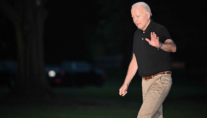 US President Joe Biden walks across the South Lawn upon return to the White House in Washington, DC on July 13, 2023. — AFP