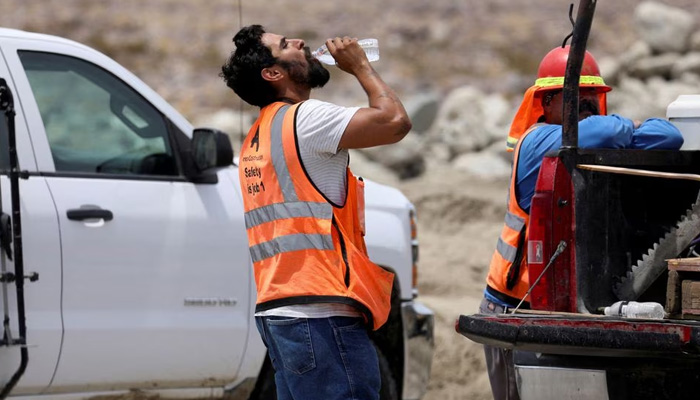 A construction worker drinks water in temperatures that have reached well above triple digits in Palm Springs, California, US. — Reuters/File