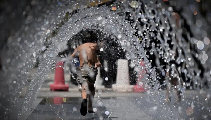 A child runs through a water fountain at Cinecitta World Park, near Rome, Italy, on July 23, 2022, during an ongoing heat wave across Europe. — AFP/File