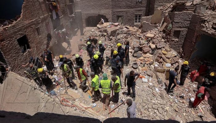 Egyptian emergency and rescue workers search for survivors in the rubble of a collapsed five-story apartment building in Hadak al-Kubba neighborhood on July 17, 2023 in Cairo, Egypt. - Reuters