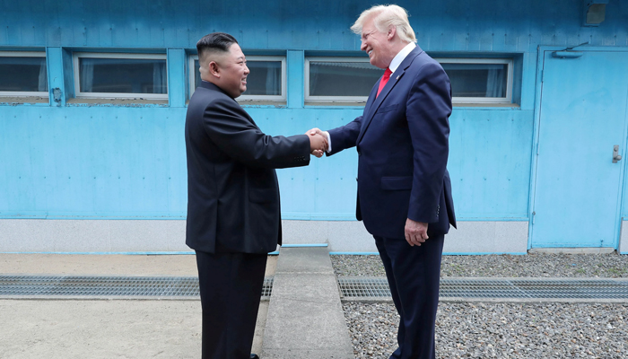 North Korean leader Kim Jong-un (left) shakes hands with then-US President Donald Trump as they meet at the demilitarised zone separating the two Koreas on June 30, 2019. — Reuters