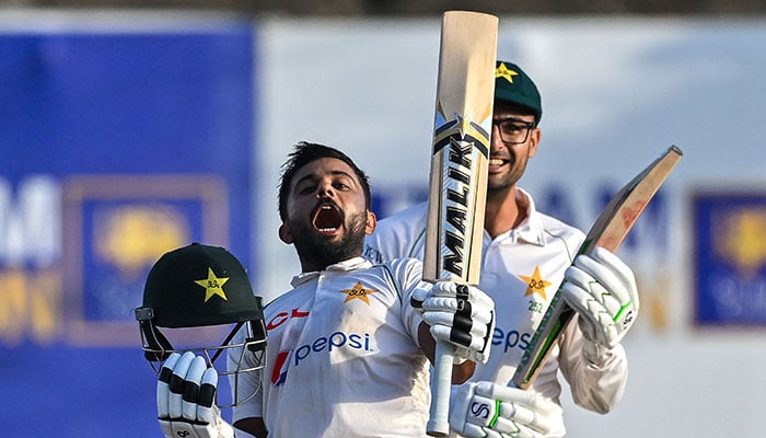 Saud Shakeel (left) of Pakistan celebrates after scoring a double century (200 runs) on the third day of the 1st Cricket Test match between Sri Lanka and Pakistan at Galle International Cricket Stadium in Galle on July 18, 2023. - AFP