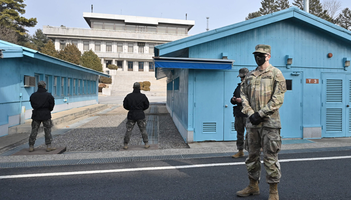 A US soldier (R) and South Korean soldiers stand guard during a media tour at the truce village of Panmunjom in the Joint Security Area (JSA) of the Demilitarized Zone (DMZ) separating North and South Korea on February 7, 2023. — AFP