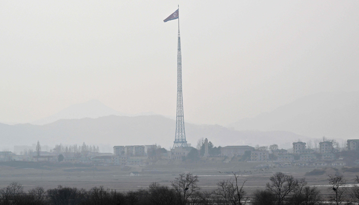 A North Korean flag flutters in the wind at the propaganda village of Gijungdong in North Korea as seen from a South Korean checkpoint during a media tour at the truce village of Panmunjom in the Joint Security Area (JSA) of the Demilitarized Zone (DMZ) separating two Koreas on February 7, 2023. — AFP