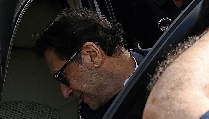 PTI Chairman Imran Khan leaves the High Court in Islamabad on June 12, 2023. — AFP