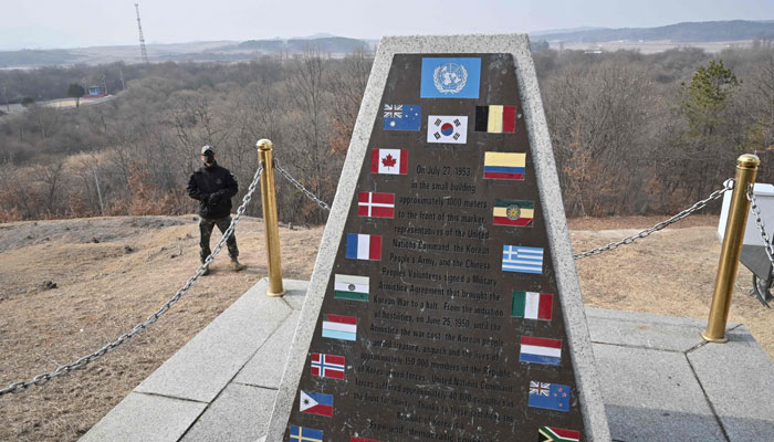 A South Korean soldier stands guard next to a monument installed at a South Korean checkpoint during a media tour of the truce village of Panmunjom in the Joint Security Area (JSA) of the Demilitarized Zone (DMZ) separating North and South Korea on February 7, 2023. — AFP