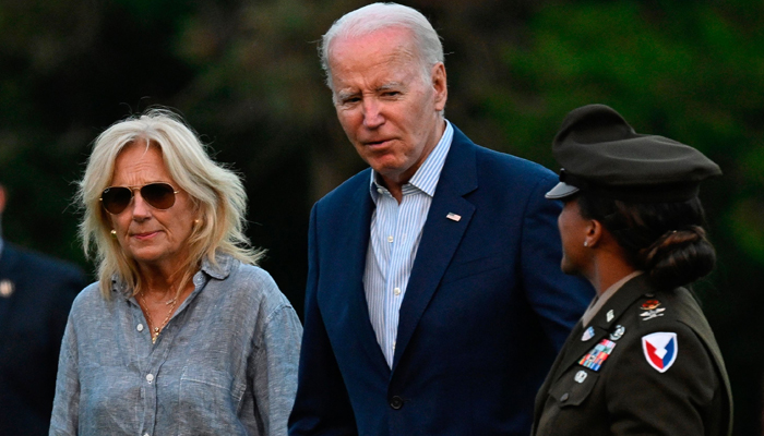 US President Joe Biden and First Lady, Jill Biden walk away from Marine One at Fort McNair in Washington, DC on July 16, 2023, after spending the weekend in Camp David. — AFP