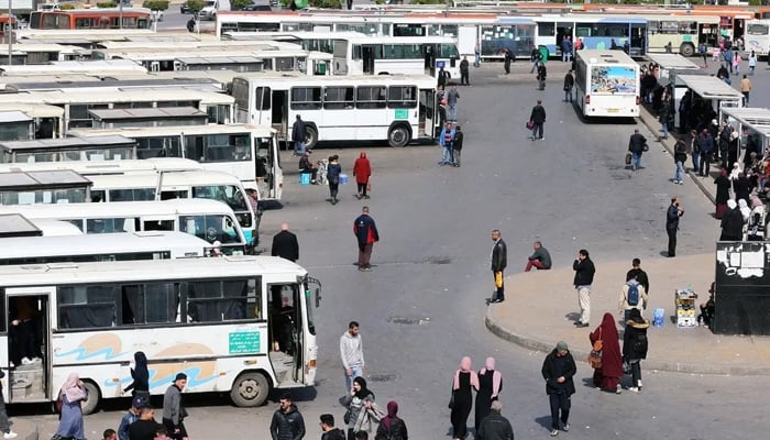 People can be seen roaming around at a bus stand in Algeria. — Reuters/File