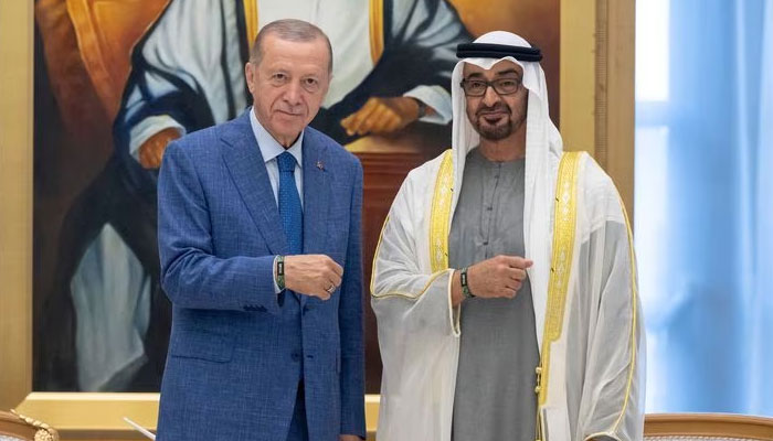 Sheikh Mohamed bin Zayed Al Nahyan, President of the United Arab Emirates and Recep Tayyip Erdogan, President of Turkey, stand for a photograph wearing a 2023 UN Climate Change Conference (COP 28) wristbands during an official reception at Qasr Al Watan in Abu Dhabi, United Arab Emirates, July 19, 2023. REUTERS