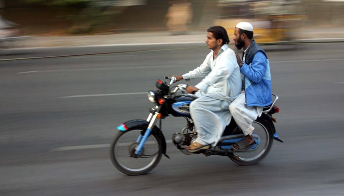 Two men commuting on a motorcycle in Karachi in this undated image. — PPI/File
