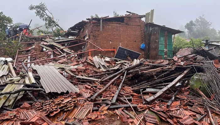 Rescuers stand next to debris of a residential house that was damaged by a landslide in Raigad district in the western state of Maharashtra, India, July 20, 2023. — REUTERS