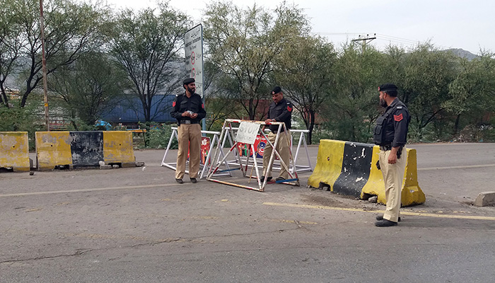 Police personnel stand guard on main GT Road in Kohat,Khyber Pakhtunkhwa on May 16, 2023. — Online