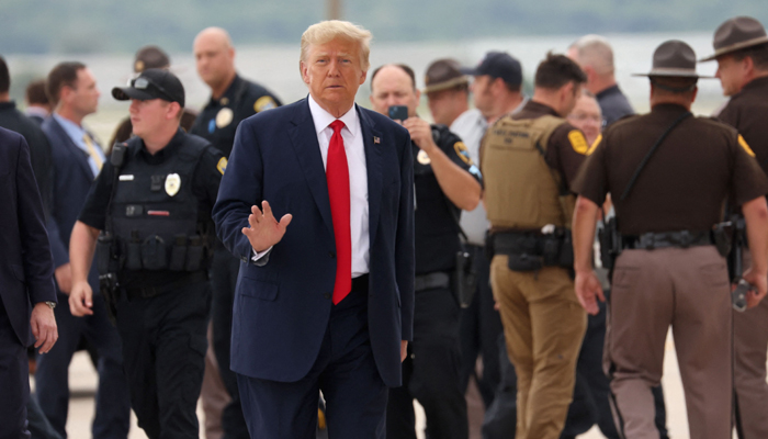 Former US President Donald Trump prepares to board his jet at the airport after holding a campaign event in Nearby Council Bluffs, Iowa on July 07, 2023, in Omaha, Nebraska. — AFP