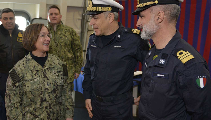 Admiral Lisa Franchetti, (left), can be seen while she was vice admiral interacting with other naval officers. — US Department of Defense