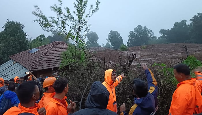 This photograph taken on July 20, 2023, shows personnel inspecting the site of a landslide at Irshalwadi village of Raigad district in Maharashtra state. — AFP