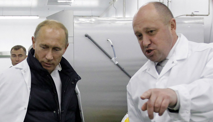 In this file photo taken on September 20, 2010, Businessman Yevgeny Prigozhin shows Russian Prime Minister Vladimir Putin his school lunch factory outside Saint Petersburg. — AFP