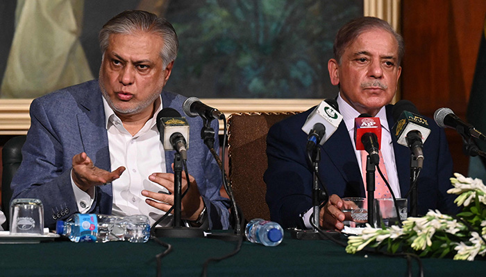Prime Minister Shehbaz Sharif (right) and Finance Minister Ishaq Dar address a press conference in Lahore on June 30, 2023. — AFP