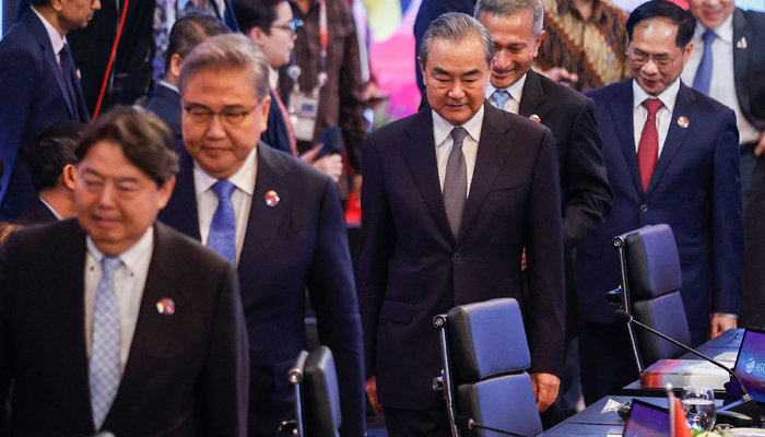 Director of the Office of the Foreign Affairs Commission of the Communist Party of Chinas Central Committee Wang Yi (center) walks after a group photo session during the ASEAN Plus Three Foreign Ministers Meeting in Jakarta on July 13, 2023. — AFP