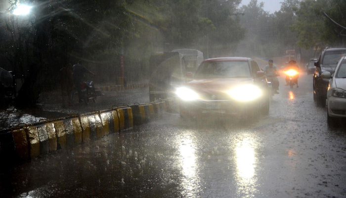 Vehicles on their way during the heavy rain in Hyderabad on July 23, 2023. — INP