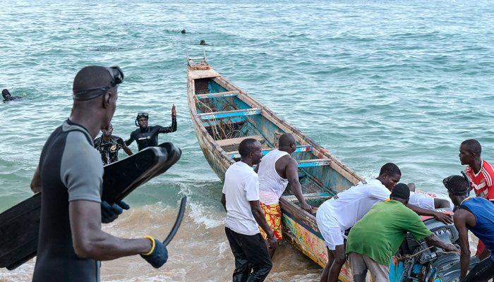 Senegalese rescue personnel and local fishermen prepare a pirogue for a rescue operation in Ouakam, in Dakar on July 24, 2023, after a boat capsized off the coast of Dakar. — AFP