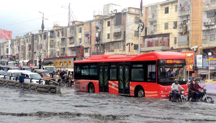 Commuters are facing difficulties in transportation due to stagnant rainwater due to poor sewerage system caused by heavy downpours of monsoon season, located at Nagan Chowrangi area in Karachi on Monday, July 24, 2023. — PPI