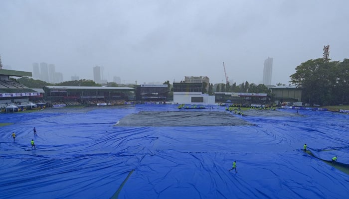 Ground staff look at the pitch after the start of the first day of the final cricket Test match between Pakistan and Sri Lanka was delayed due to rain, at the Sinhalese Sports Club (SSC) Ground in Colombo, July 24, 2023. - AFP