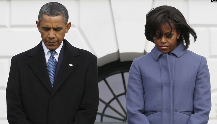 Former US President Barack Obama and former First Lady Michelle Obama take part in the moment of silence. — Reuters