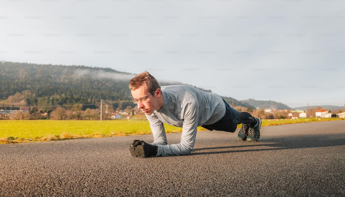 A representational image of a person busy doing plank exercises on the road. — Unsplash/File