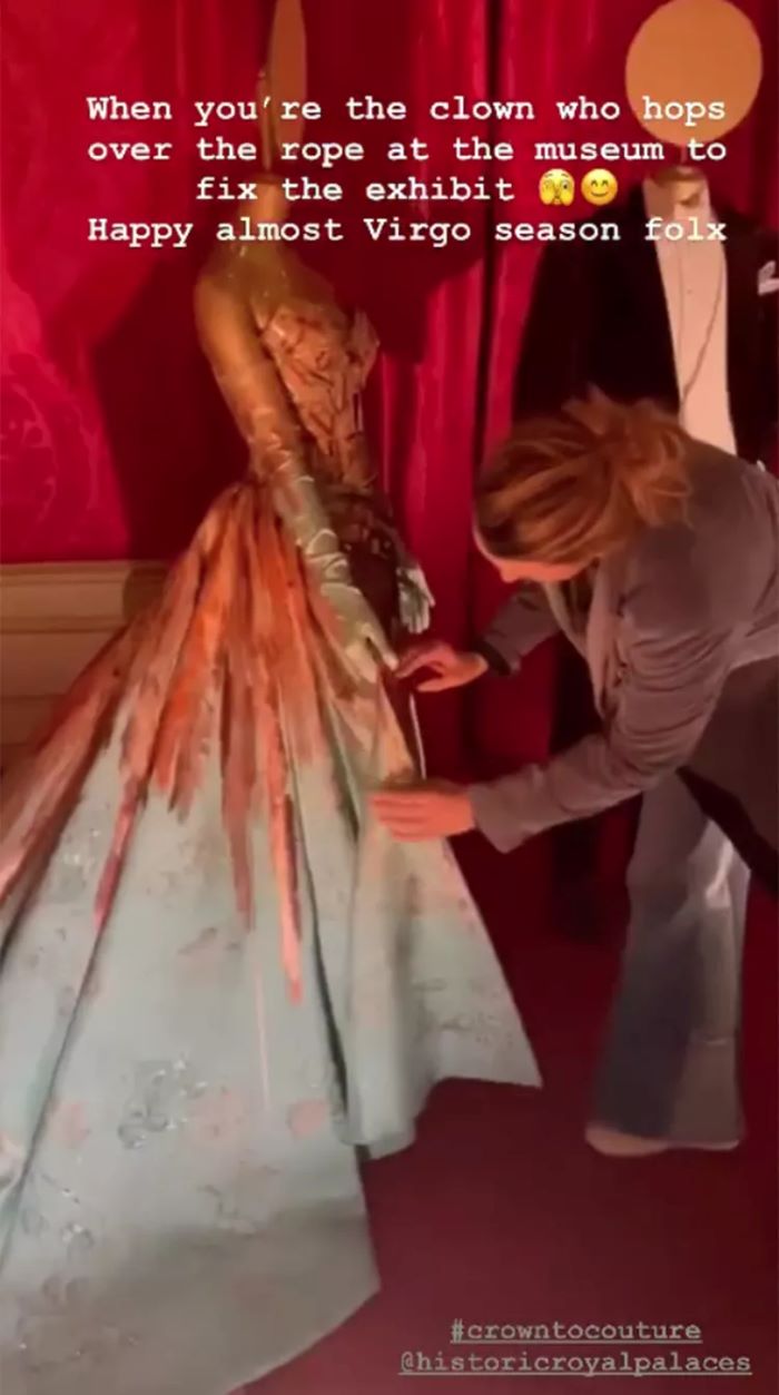 Blake Lively personally adjusts her 2022 Met Gala dress at a London exhibit, showcasing her DIY skills