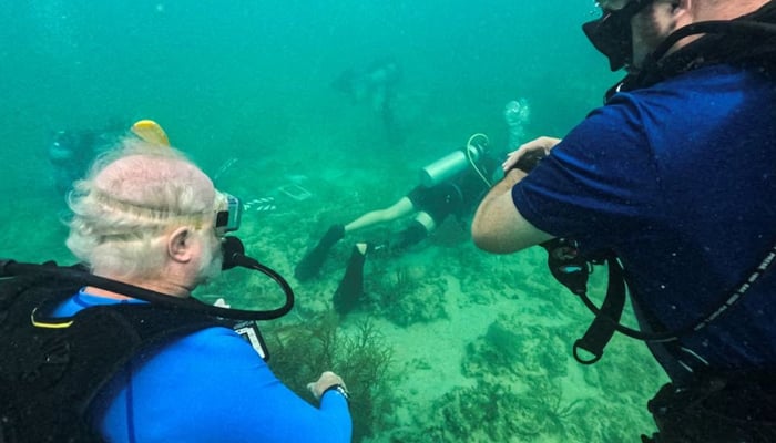 Mote Laboratory CEO Michael Crosby watches over citizen scientist planting corals on Key Wests vulnerable reefs in Key West, Florida, US, July 13, 2023. — Reuters