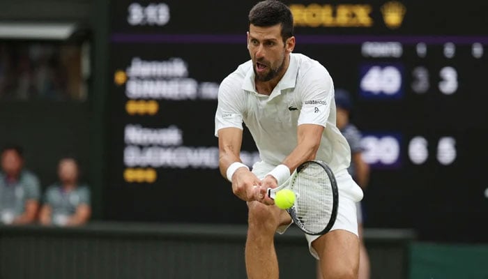 Serbia´s Novak Djokovic returns the ball to Italy´s Jannik Sinner during their men´s singles semi-finals tennis match on the twelfth day of the 2023 Wimbledon Championships at The All England Lawn Tennis Club in Wimbledon, southwest London, on July 14, 2023. — AFP