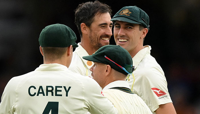 Australia´s Mitchell Starc (C) celebrates with Australia´s Pat Cummins (R) after bowling England´s captain Ben Stokes on the opening day of the fifth Ashes cricket Test match between England and Australia at The Oval cricket ground in London on July 27, 2023.—AFP