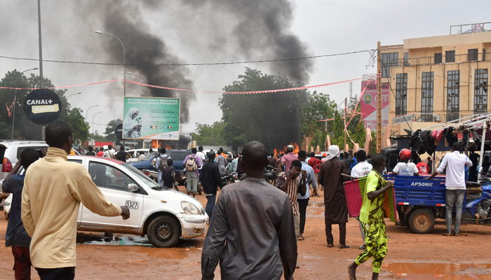 A general view of billowing smoke as supporters of the Nigerien defence and security forces attack the headquarters of the Nigerien Party for Democracy and Socialism (PNDS), the party of overthrown President Mohamed Bazoum, in Niamey on July 27, 2023. — AFP