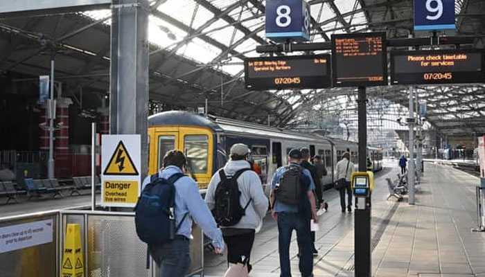 Passengers walk at Liverpool Lime Street Station in the UK.— AFP/File