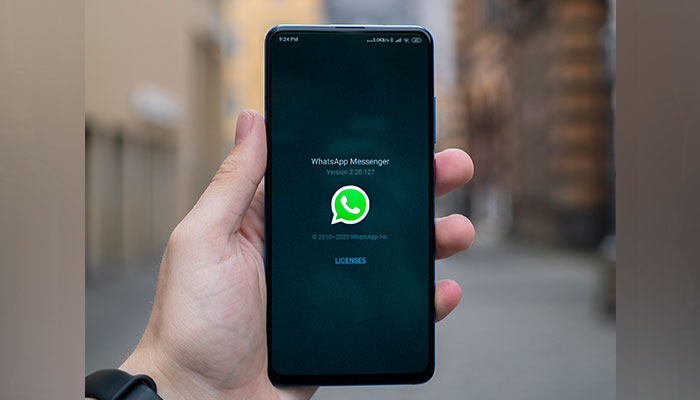The picture shows a person holding a cell phone. — Unsplash