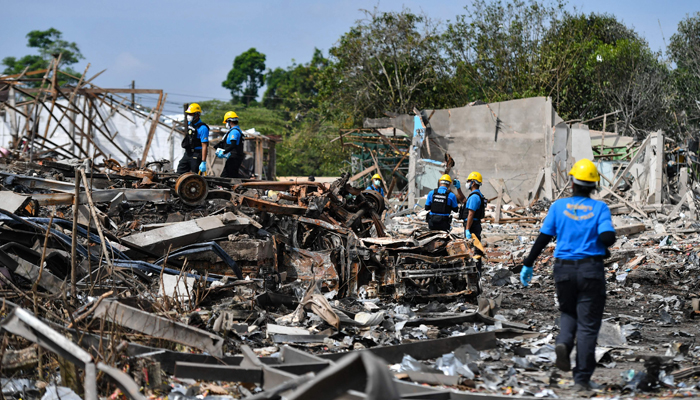 Forensic personnel inspect the site of an explosion that ripped through a firework warehouse in Sungai Kolok district Narathiwat province on July 30, 2023. — AFP